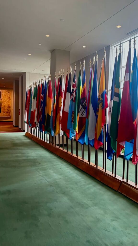 Flags at an international institution representing UN classification standards linked to KBLI 2025 alignment
