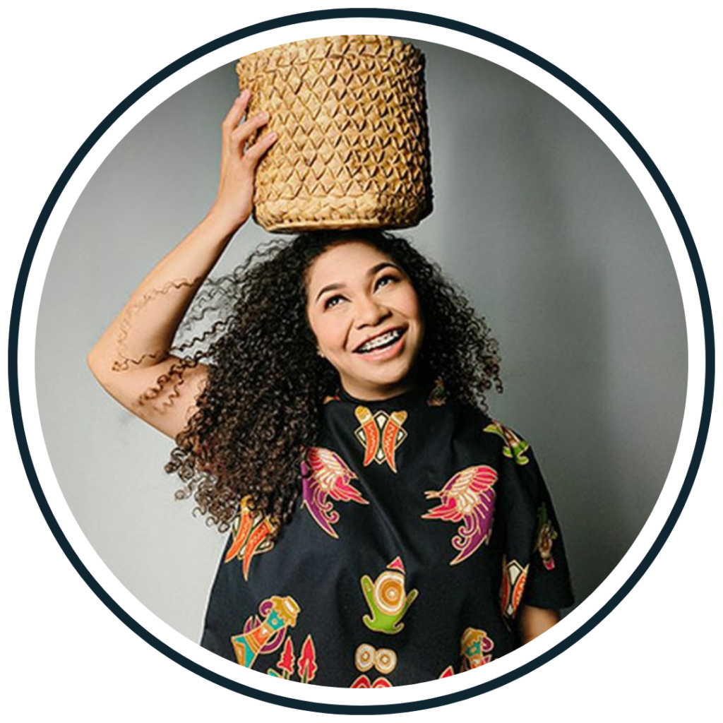Hanna Keraf, co-founder of Du'Anyam, with a woven lontar-leaf basket, illustrating a women's weaving social enterprise in eastern Indonesia.