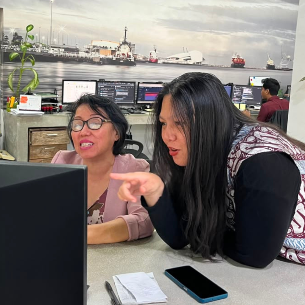Two members of the TraceWorthy team working together at a screen in the Indonesia office, the human-centred approach behind advising founders on self-funded growth.