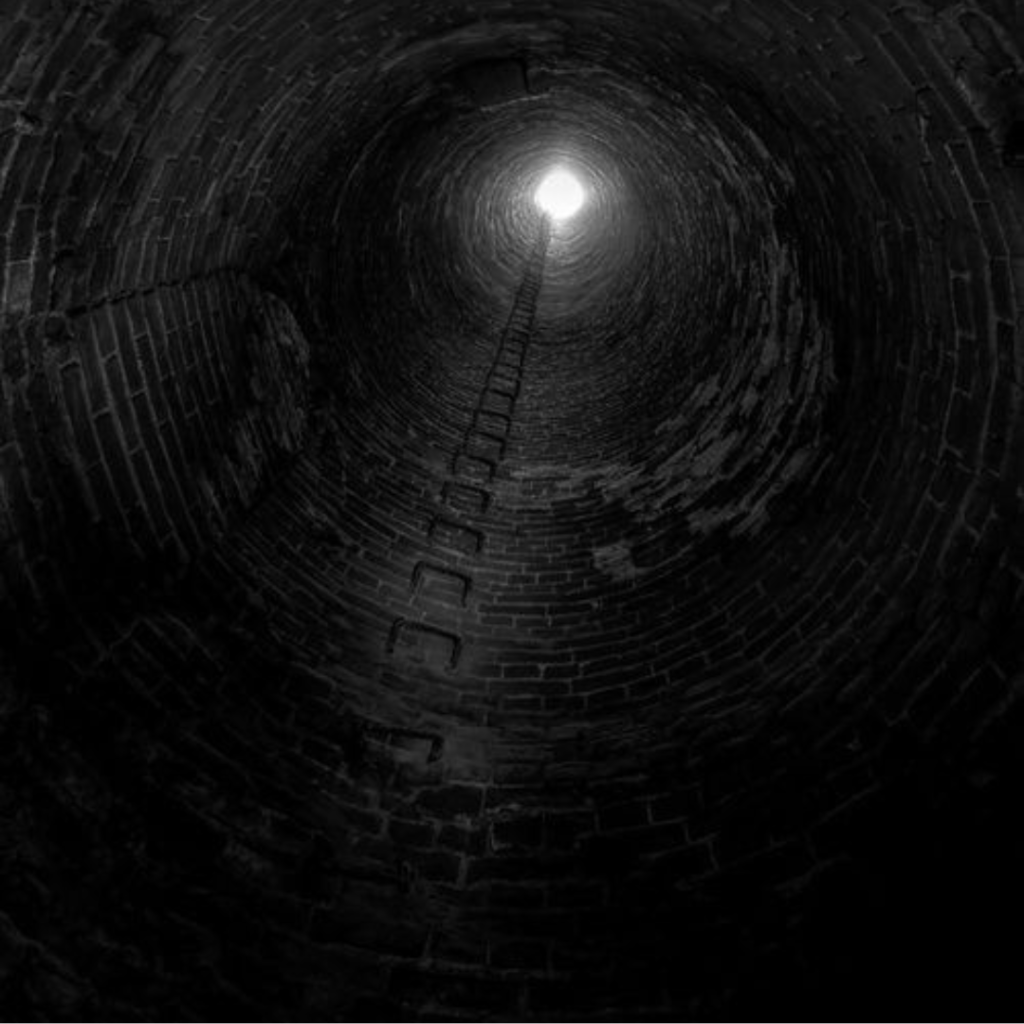 View up a dark brick shaft to daylight, with a ladder rising to it, illustrating the trap of rolling short-term debt and the route out.