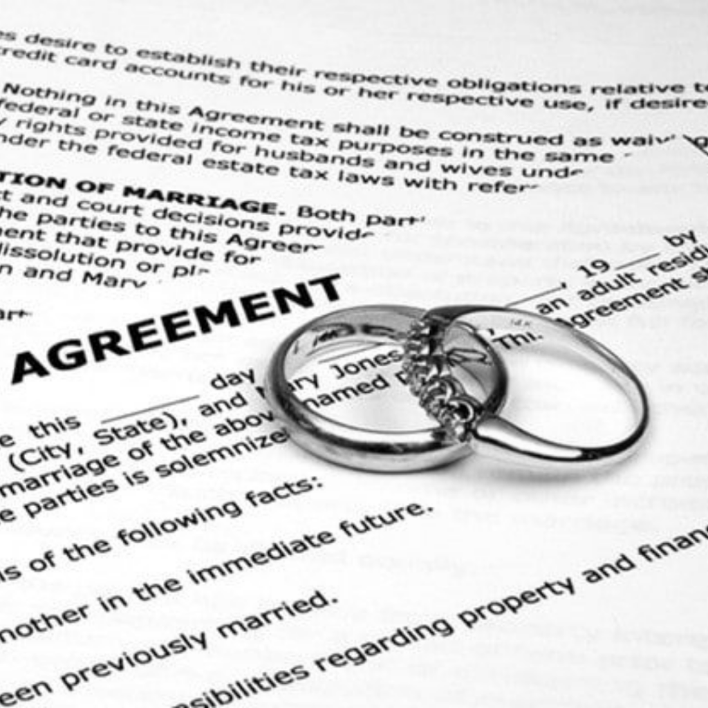 A prenuptial agreement document with two wedding rings, illustrating a marriage agreement that separates a couple's property in Indonesia.